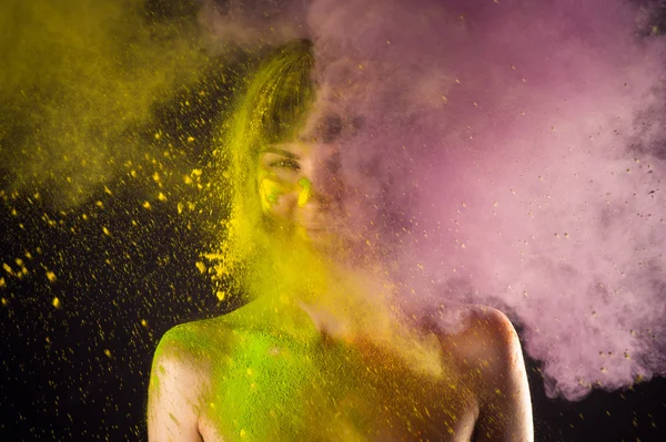 Attractive girl in Holi colors on a black — Stock Photo, Image