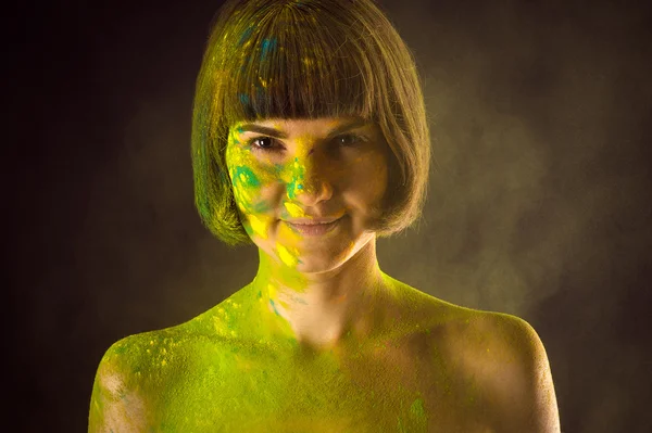 Portrait of a smiling woman in colors Holi — Stockfoto