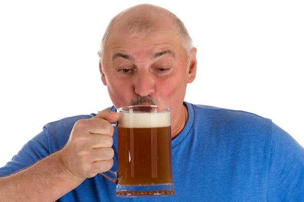 Gray haired man drinking beer from a mug — Stock Photo, Image