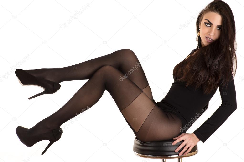 luxurious woman in stockings sitting on a chair