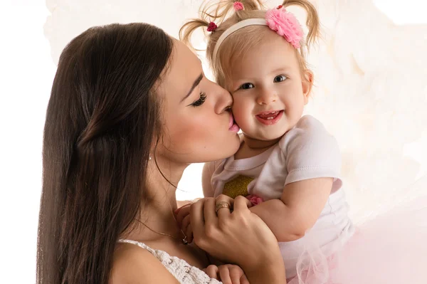 Beautiful profile face woman kissing daughter — Stock Photo, Image