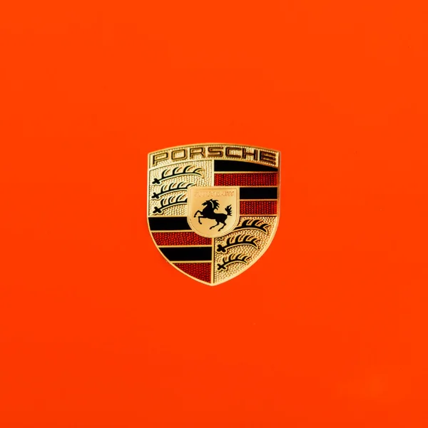 Logo of PORSCHE on red texture. — Stock Photo, Image