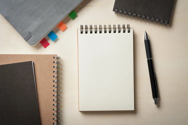 Notepad on wood table — Stock Photo, Image