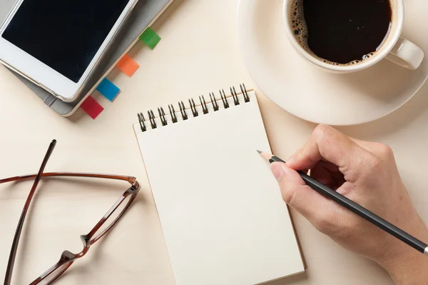 Small notebook and coffee cup