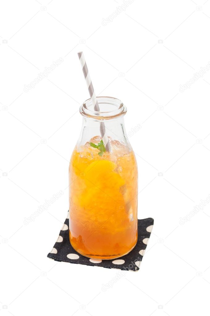 Iced peach tea in glass bottle