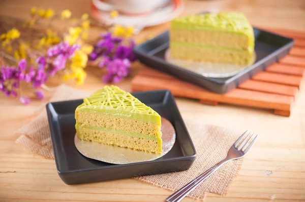 Green tea cake on wood table — Stock Photo, Image