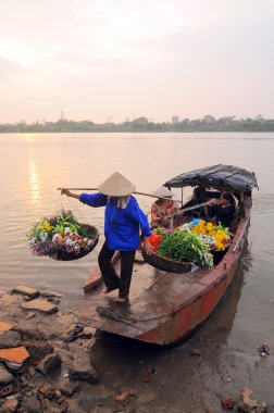 Unidentified florist vendor in the small market at April 21,2014 in hanoi, vietnam.