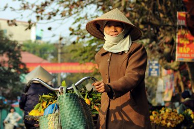 Unidentified florist vendor in the small market at April 21,2014 in hanoi, vietnam.