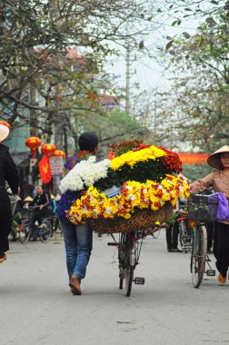 Vietnam florist vendor in a small market at February 02, 2013 in Hanoi, Vietnam.