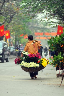 Vietnam florist vendor in a small market at February 02, 2013 in Hanoi, Vietnam.