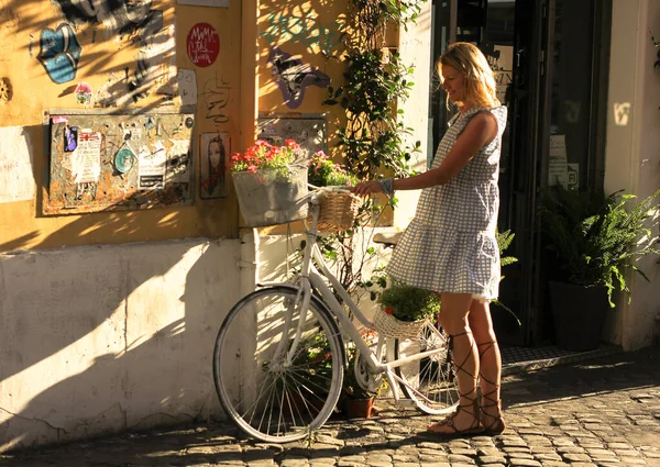 girl with bicycle on the street in Rome,Italy