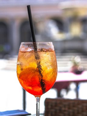 Bulanık şehir arkaplanıyla çevrili aperol spreyli kokteyl camları.