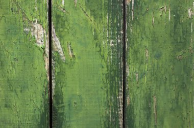 Ahşap, yeşil bir duvarın arka planı, zaman hasarlı bir yapısı var. 