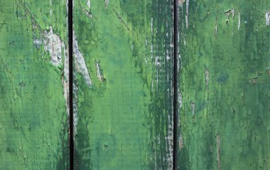 Ahşap, yeşil bir duvarın arka planı, zaman hasarlı bir yapısı var. 