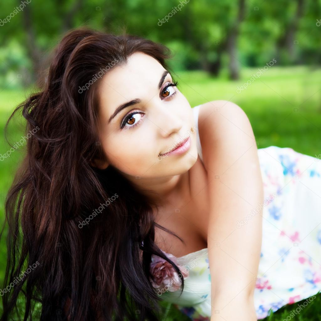 Beautiful woman in the summer park
