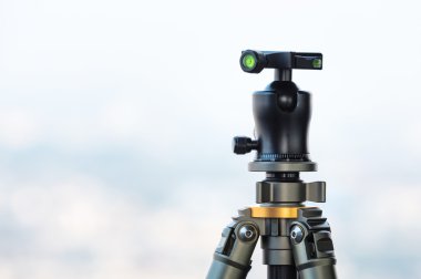 Camera Tripod and Ball head with blur sky in background 