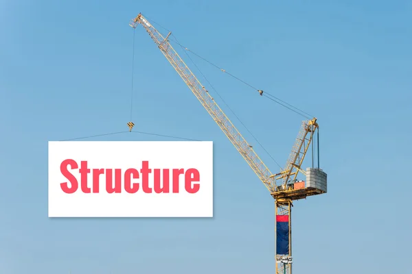 Industri konstruktion kran som håller en skylt med struktur text på Blue Sky bakgrund. — Stockfoto