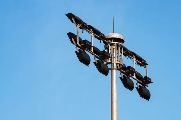 Parte posterior del poste del proyector en fondo azul del cielo en el estadio de la arena del deporte — Foto de Stock