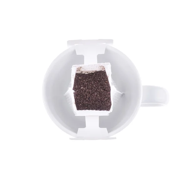 Drip bag coffee hanging on a coffee cup isolated on white background. — Stock Photo, Image