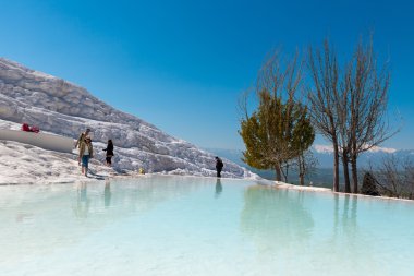 Tourists on Pamukkale travertines, Turkey.