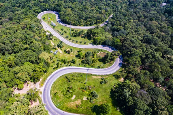 Aerial view of cars are going through a curve  road on the nature mountain — Stock Photo, Image