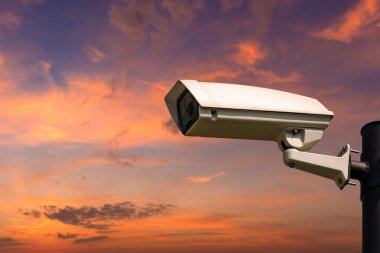 Single CCTV Security camera on beautiful sunrise sky and clouds 
