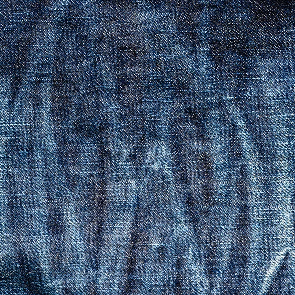Textura de velho azul jeans têxtil close-up com fade de longo t — Fotografia de Stock