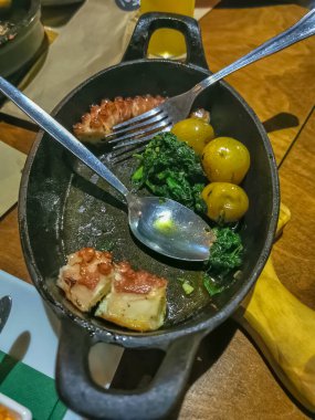 View of a typical Portuguese dish with grilled octopus, potato, spinach and garlic, in Portugal it is called polvo lagareiro