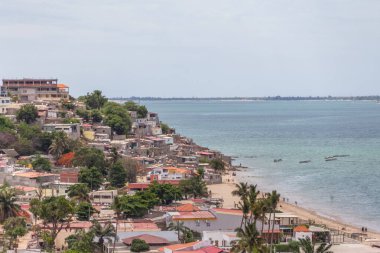 Luanda / Angola - 12/07/2020: Beach view with fishermen and traditional Angolan boats, ghetto neighborhood on the sea coast in Luanda beach, Mussulo Island as background