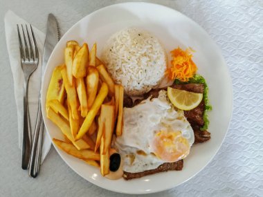 Tipik bir Portekiz fast-food 'u olan bitoque, kızarmış patates, pirinç, sahanda yumurta ve ızgara biftek....