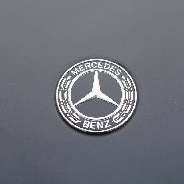 Ivanovo, Russia - November 13, 2020: Mercedes benz logo and badge on the car. Close up of chromium-plated metal logotype on the dark background.