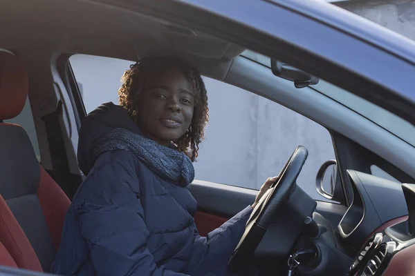 the beautiful and happy African American in the car