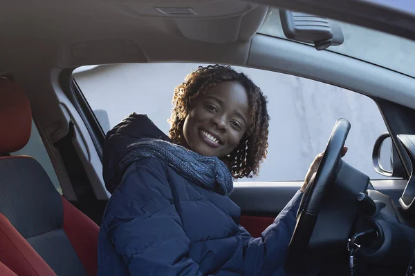 the beautiful and happy African American in the car