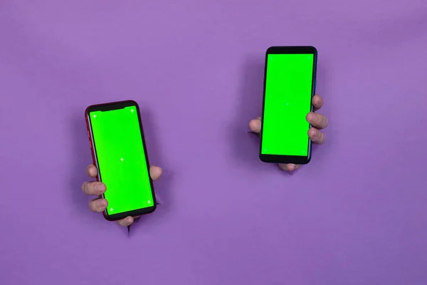 Two Smartphones Green Screen Hands Purple Background Hand Slot Background — Stock Photo, Image