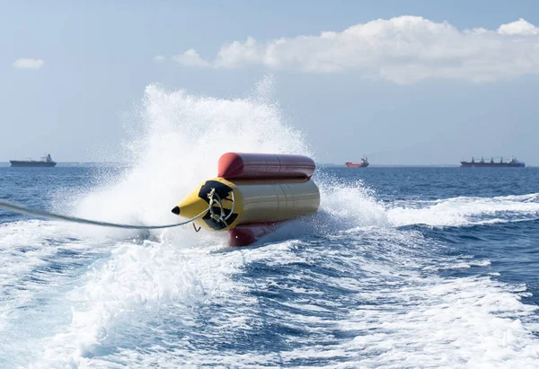 Water sports inflatable banana turned over during an extreme ride