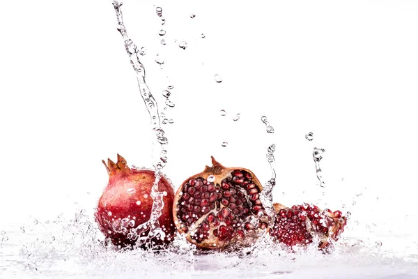 Spritzer Süßwasser Auf Ganze Granatapfelfrüchte Und Saftige Körner — Stockfoto