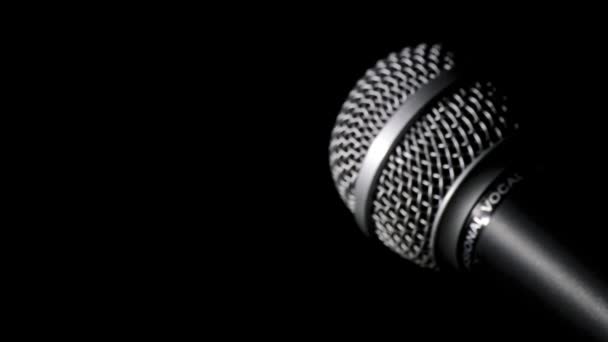 Radio microphone gyrating at black background — Stock Video