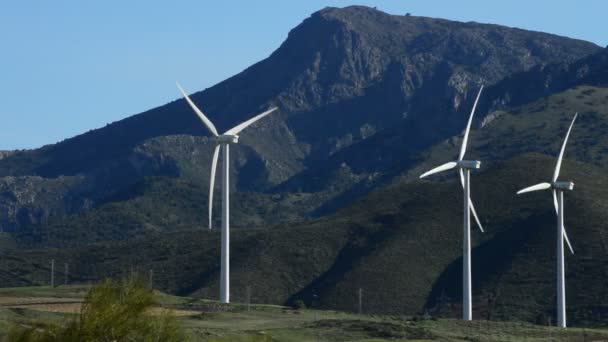 Wind turbines energy rotating together at mountains at sunny day — Stock Video