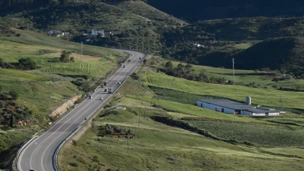 Krajina, horská silnice s zelená pole s provozem na slunečný den — Stock video