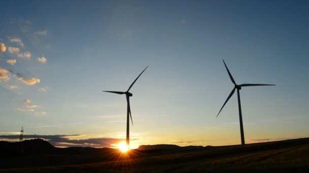 Windräder drehen sich bei Sonnenuntergang auf dem Feld — Stockvideo