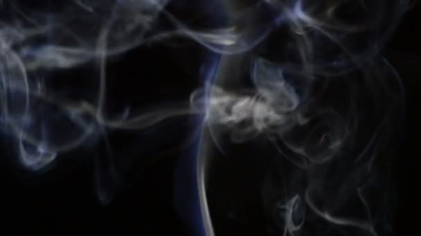 Column of smoke with strands moving at wind at black background — Stock Video