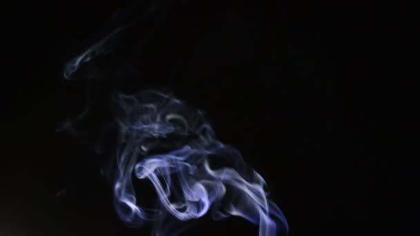 Column of smoke with strands moving at wind at black background — Stock Video