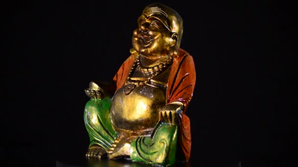 Buda sorrindo e gordura girando no fundo preto — Vídeo de Stock