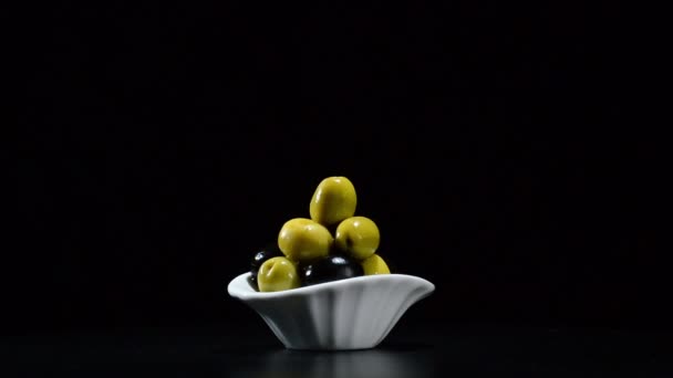 Azeitonas frutas verde e preto girando em fundo preto — Vídeo de Stock