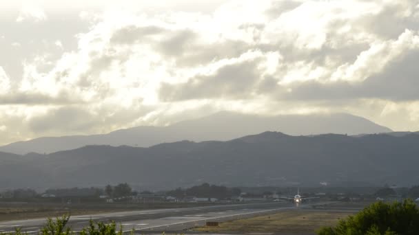 Airplane of passenger taking off from airport at cloudy day at sunset — Stock Video