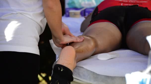 Fisioterapia aplicada a un atleta después de un esfuerzo deportivo — Vídeos de Stock