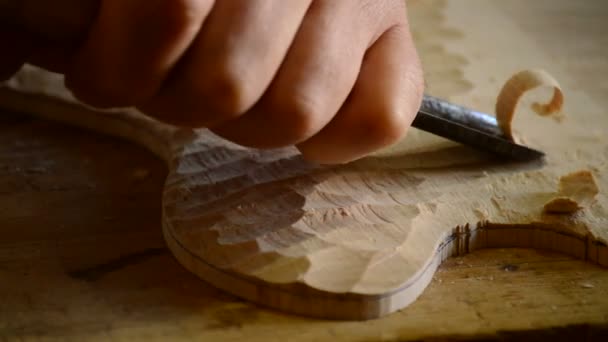 Luthier manufacturing a instrument with a chisel — Stock Video