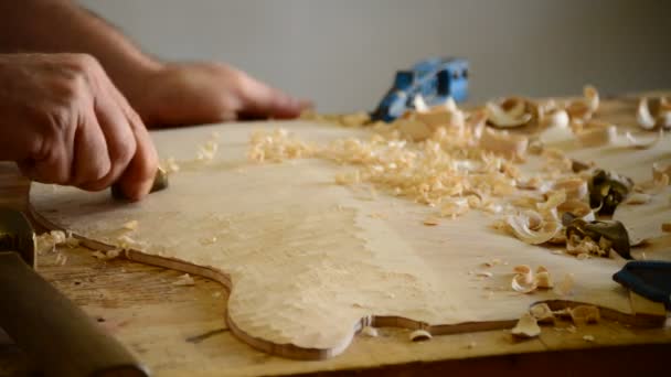 Luthier trabajando en la parte superior de un instrumento arqueado — Vídeos de Stock