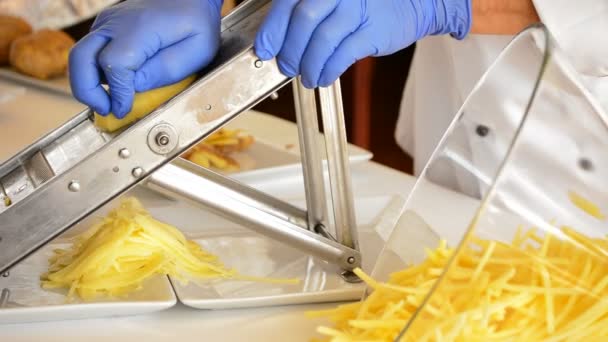 Chef hands cutting potatoes with mandolin — Stock Video