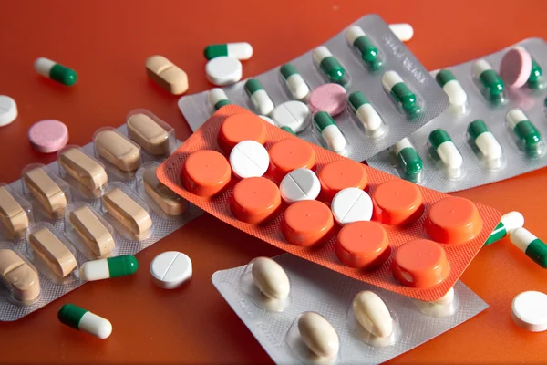 Medication on an orange background. — Stock Photo, Image